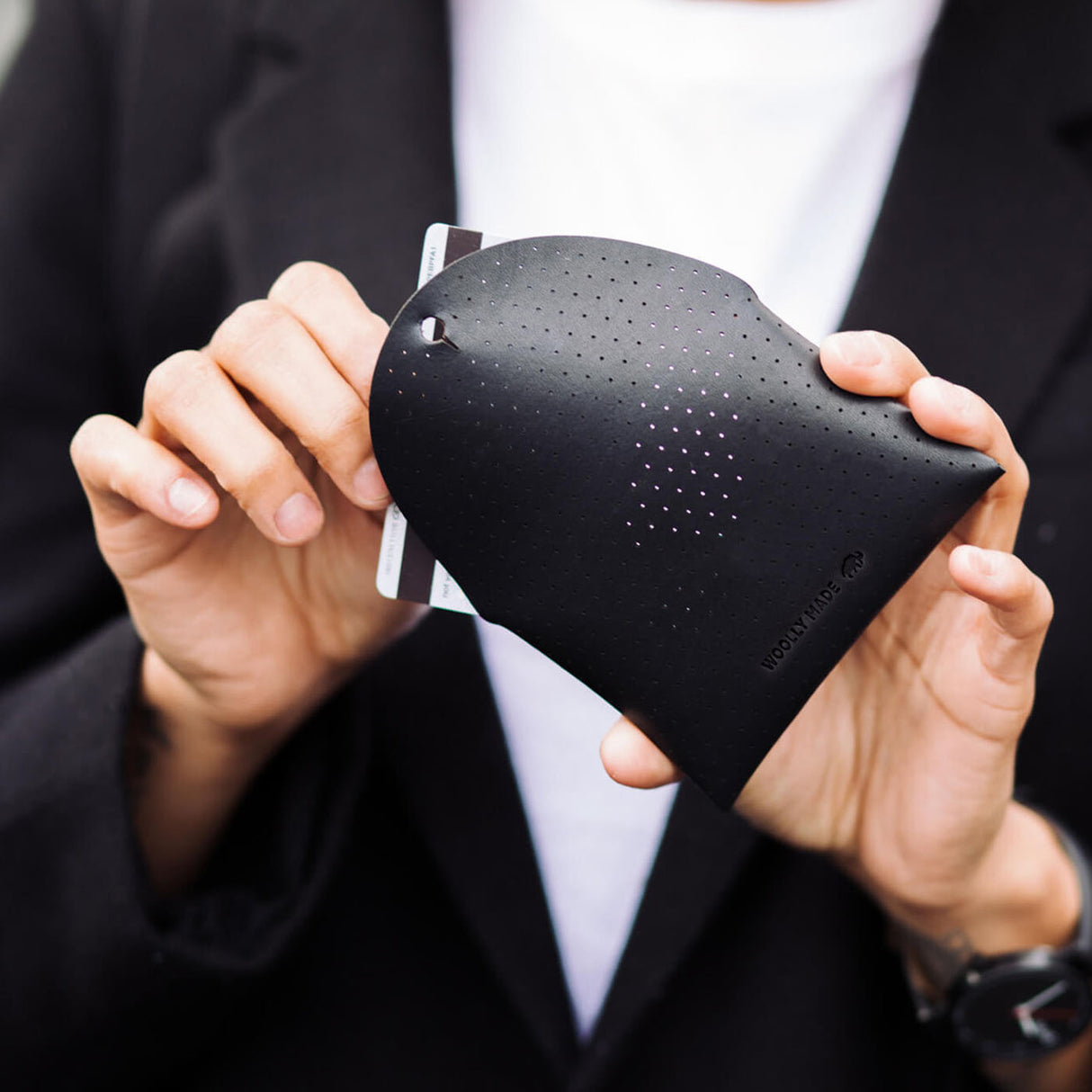 Pouch in black leather with perforated design