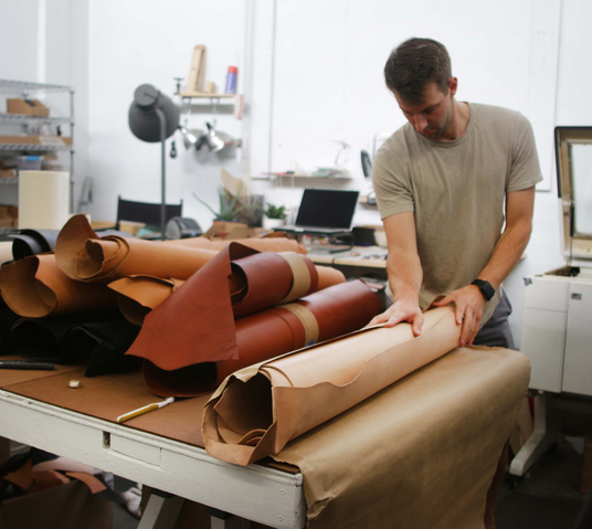 Cofounder Jeff unwrapping rolls of leather