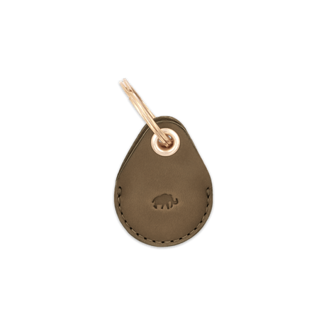 Olive leather AirTag case with debossed Woolly Made logo and brass hardware.