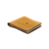 Gold leather Cash Magnet Wallet 3/4 angle view with folded bills and etched Woolly Made logo.