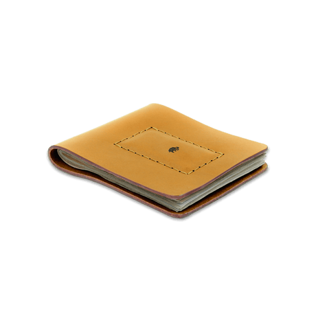 Gold leather Cash Magnet Wallet 3/4 angle view with folded bills and etched Woolly Made logo.