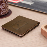 Woolly Made Cash Magnet Wallet in Olive on a table.