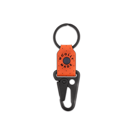 Orange leather Clip Keychain, etched Woolly Made logo, decorative perforation, and black hardware.