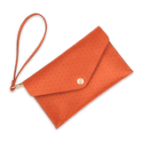 Orange leather Clutch, decorative perforation, attached matching wrist strap, and brass hardware.