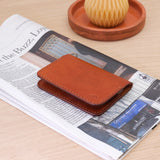 Woolly Made Flip Wallet in Brown. On top of a recent New York Times Newspaper.