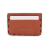 Brown leather Founders Wallet back view with hand-pressed Woolly Made logo and a white card.