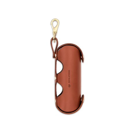 Brown Golf Ball Sleeve with side view and Woolly Made logo deboss.