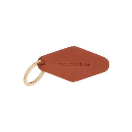 Brown leather diamond-shaped Hotel Keychain with hand-pressed Woolly Made logo and brass hardware.