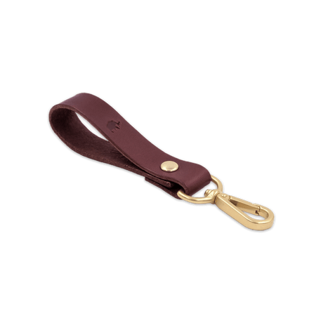 Burgundy leather Loop Keychain 3/4 angle view with brass hardware and hand-pressed Woolly Made logo.