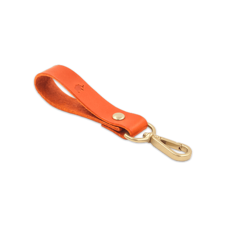 Orange leather Loop Keychain 3/4 angle view with brass hardware and hand-pressed Woolly Made logo.