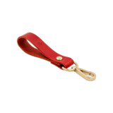 Red leather Loop Keychain 3/4 angle view with brass hardware and hand-pressed Woolly Made logo.