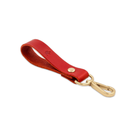 Red leather Loop Keychain 3/4 angle view with brass hardware and hand-pressed Woolly Made logo.