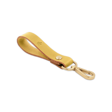 Yellow leather Loop Keychain 3/4 angle view with brass hardware and hand-pressed Woolly Made logo.