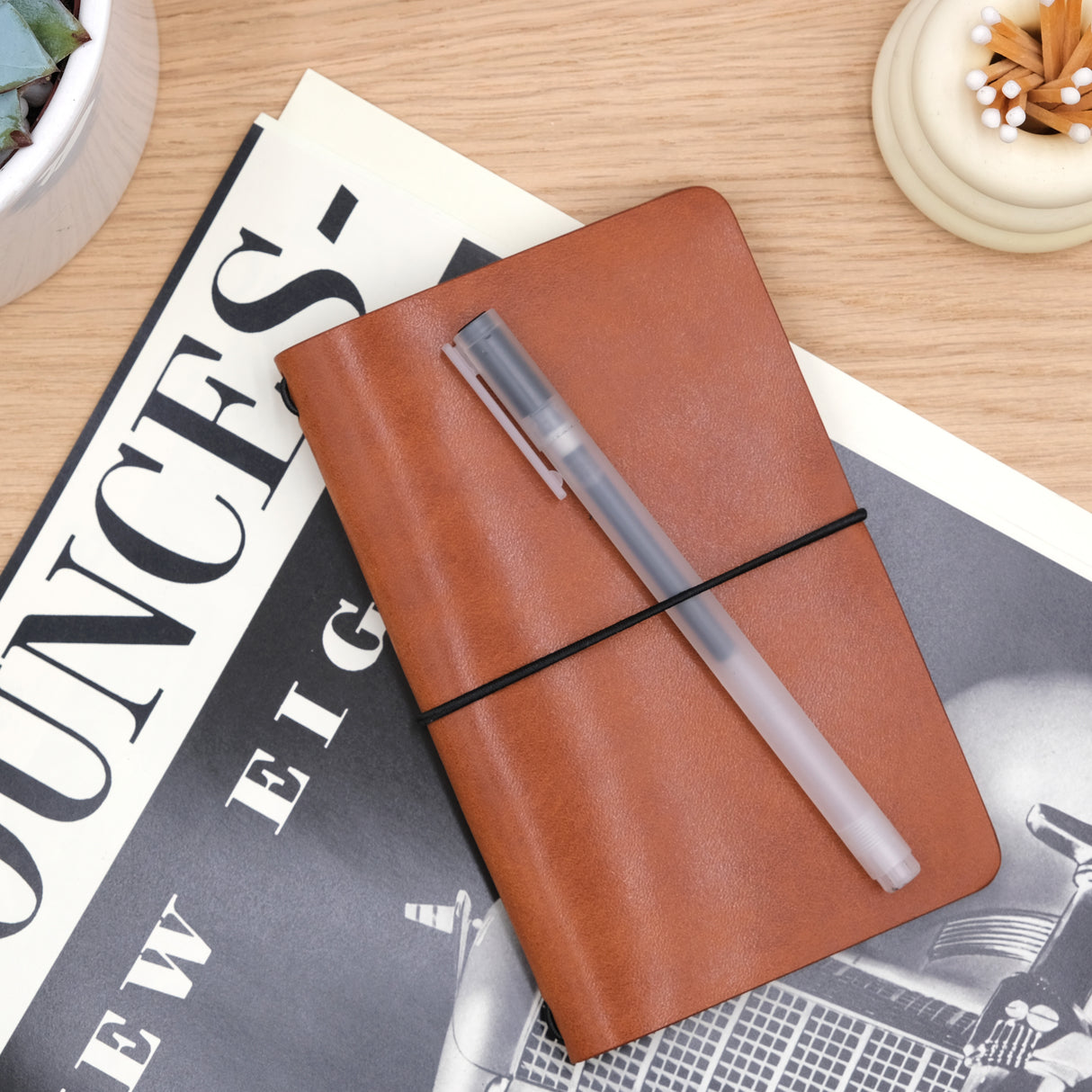 Woolly Made Pocket Journal  in brown on. table on top of a vintage magazine.