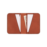 Brown leather Portrait Wallet, white cards, folded $20 bill, and hand-pressed Woolly Made logo.