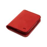 Red leather Portrait Wallet 3/4 angle view with hand-pressed Woolly Made logo.