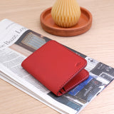 Woolly Made Portrait Wallet in Red. On a folded up newspaper.