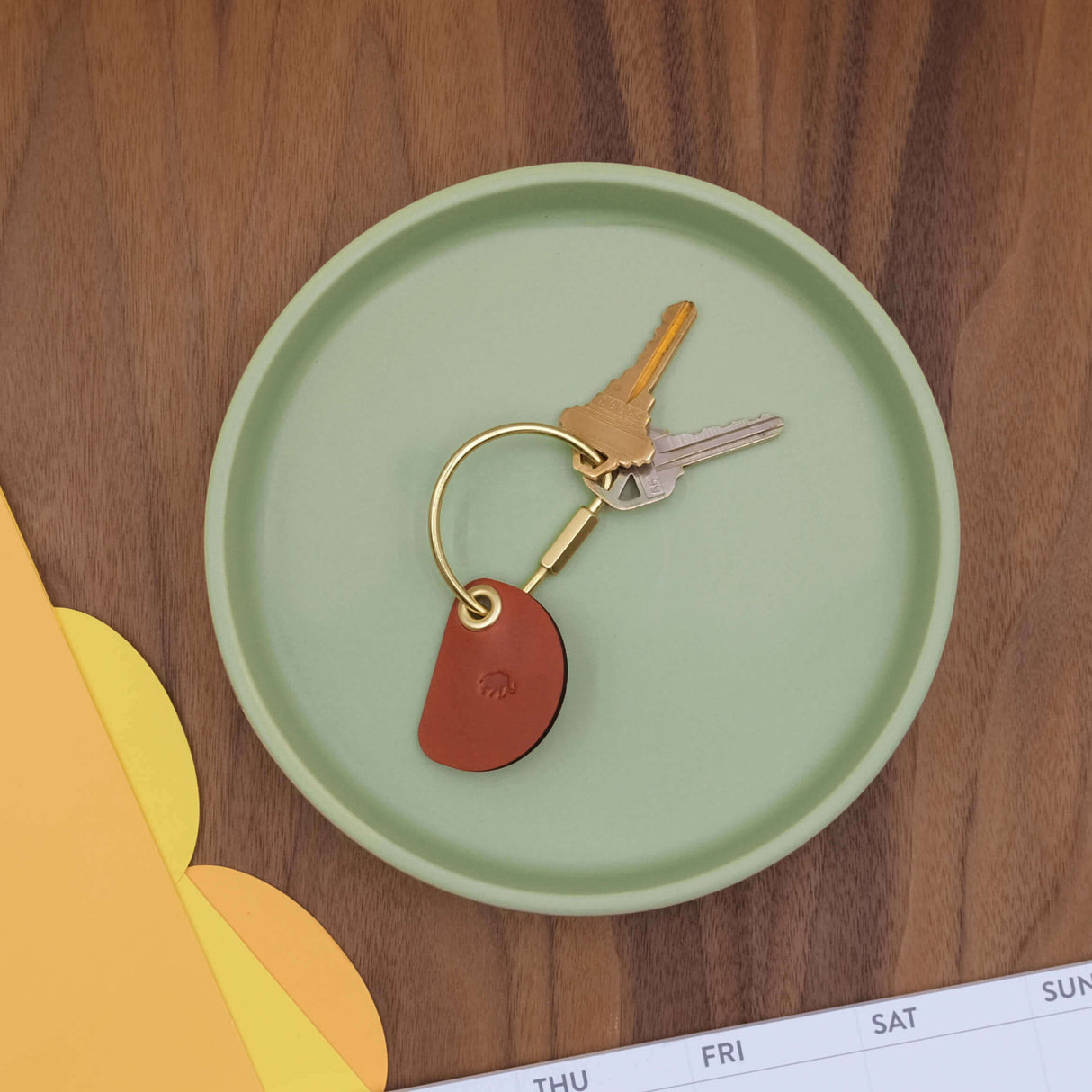 Crescent Keychain in brown leather lifestyle shot.