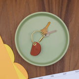 Crescent Keychain in brown leather lifestyle shot.