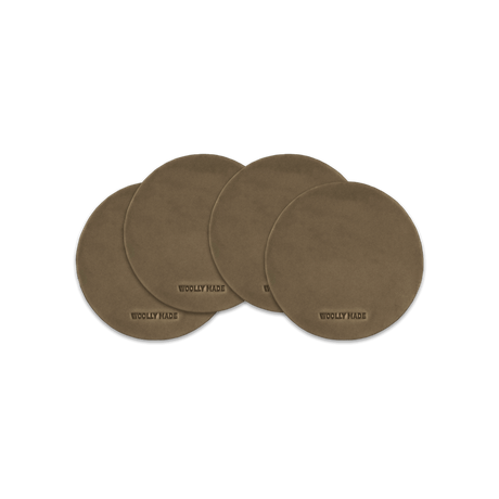 Olive leather round coaster set with hand-pressed Woolly Made logo spread out.