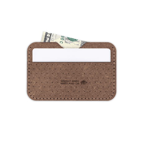 Plant leather Slim Wallet, decorative perforation, white card, folded bill, etched Woolly Made logo.