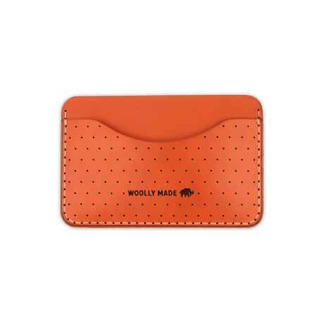 Orange leather Slim Wallet with decorative perforation and etched Woolly Made logo.