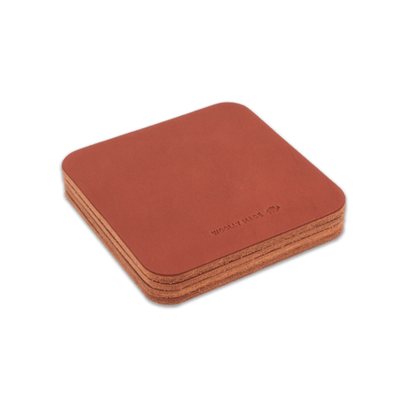 Brown leather square coaster set with hand-pressed Woolly Made logo stacked.