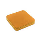 Gold leather square coaster set with hand-pressed Woolly Made logo stacked.