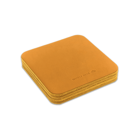 Gold leather square coaster set with hand-pressed Woolly Made logo stacked.