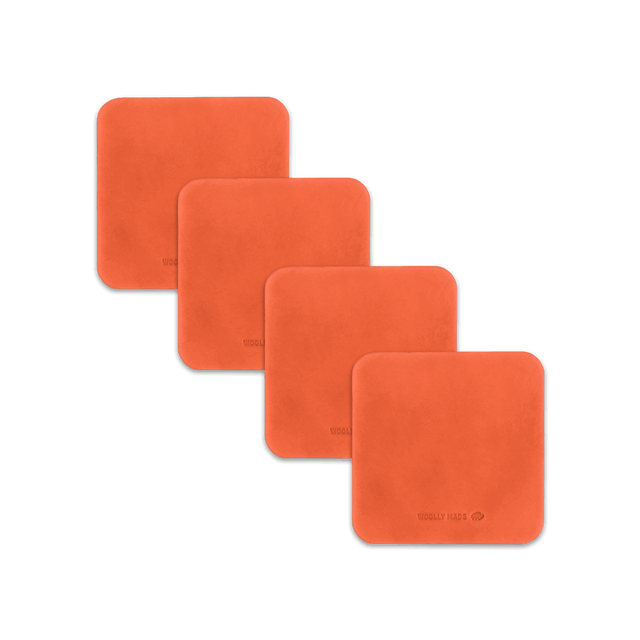 Orange leather square coaster set with hand-pressed Woolly Made logo spread out.