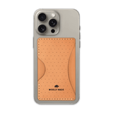 Tan leather Stick-On Wallet with decorative perforation and etched Woolly Made logo on iPhone.