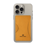 Gold leather Stick-On Wallet with decorative perforation and etched Woolly Made logo on iPhone.