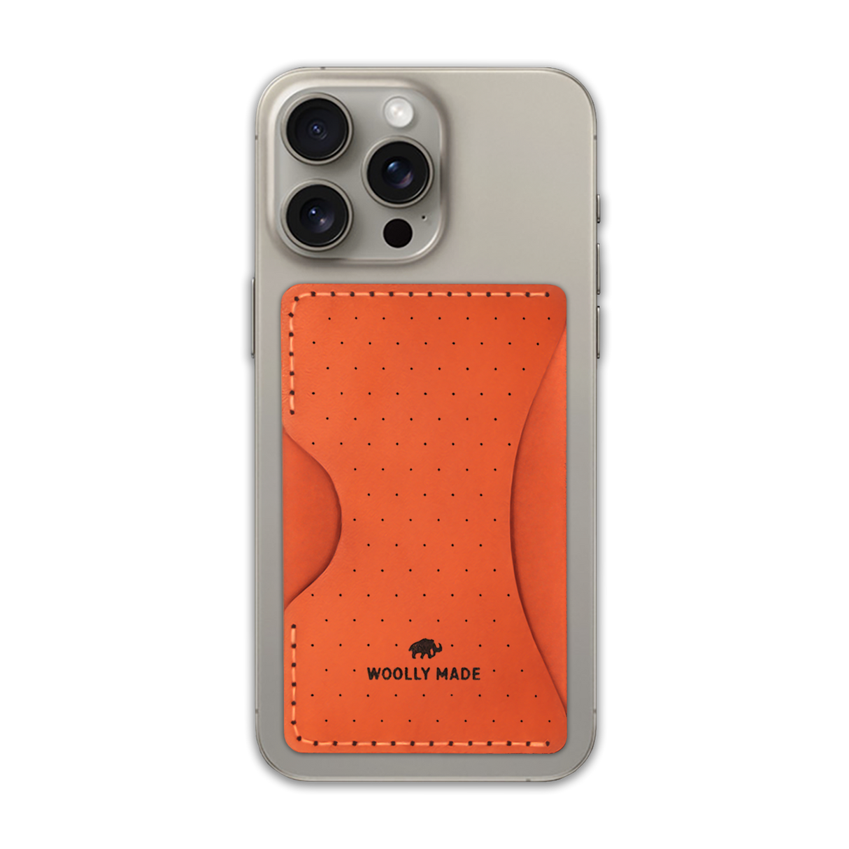 Orange leather Stick-On Wallet with decorative perforation and etched Woolly Made logo on iPhone.