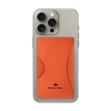 Orange leather Stick-On Wallet with decorative perforation and etched Woolly Made logo on iPhone.