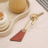 Teardrop Keychain in brown leather in a lifestyle scene.
