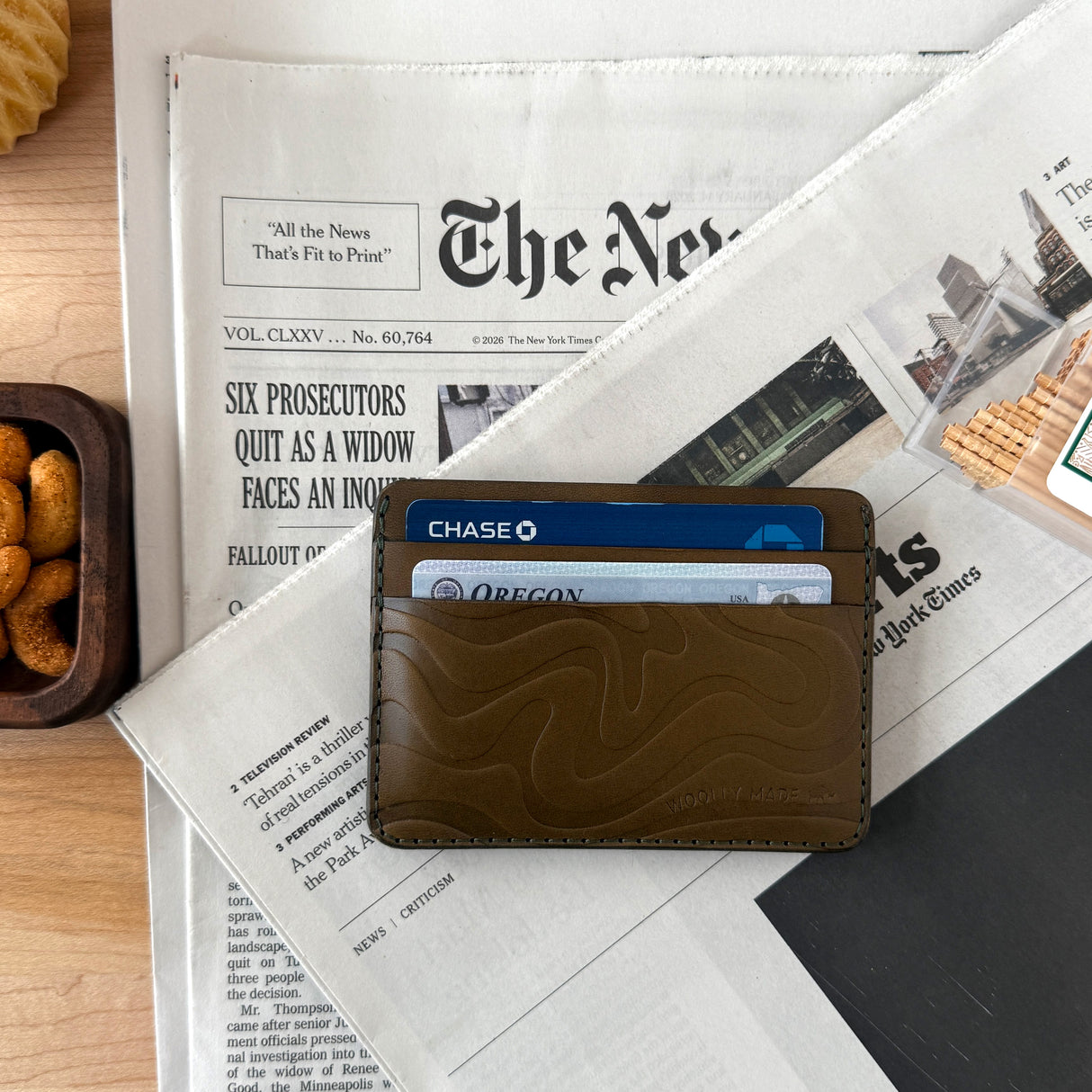Woolly Made Contour Olive Wallet on newspaper. 