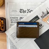 Woolly Made Contour Olive Wallet on newspaper. 