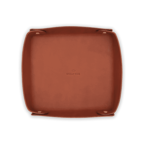 Top down view of brown leather Valet Tray with hand-pressed Woolly Made logo and brass hardware.