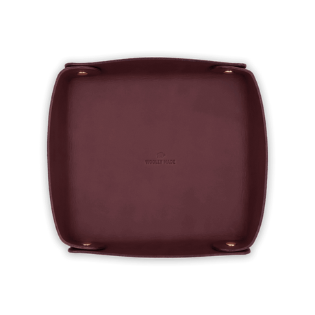 Top down view of burgundy leather Valet Tray with hand-pressed Woolly Made logo and brass hardware.