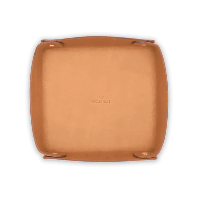 Top down view of tan leather Valet Tray with hand-pressed Woolly Made logo and brass hardware.