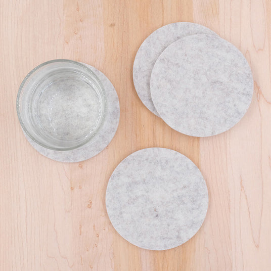 Top down view of a set of light gray Woolsters with a glass of water.