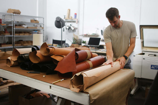 Cofounder Jeff unrolling hides of leather in the Portland Studio.