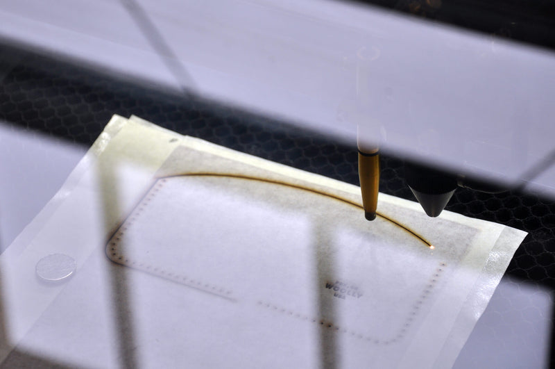 Laser cutting of a leather wallet.